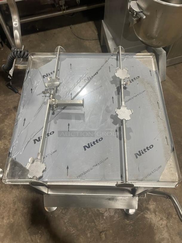 M&E Deli Pro Series stainless steel equipment cart with slicer-mounting. Features undershelf, legs, and casters. Nitto markings.