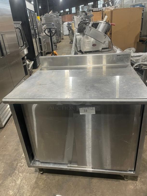 Eagle Group stainless steel worktable, 30"x36", model CB3036SEBSCS, with enclosed cabinet base, up-turned backsplash, on legs.