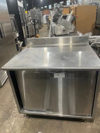 Eagle Group stainless steel worktable, 30"x36", model CB3036SEBSCS, with enclosed cabinet base, up-turned backsplash, on legs.