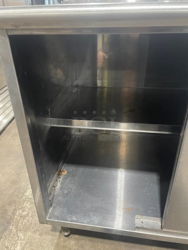 Eagle Group stainless steel worktable, 30"x36", with enclosed cabinet base, upturned backsplash, model CB3036SEBSCS, on legs.