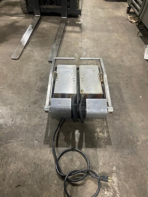 Commercial stainless steel electric powered dual panini press grill with legs; features two grill plates, visible power cord.
