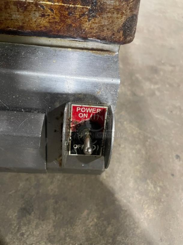 Commercial stainless steel electric countertop dual panini press grill with power toggle switch, well-used condition.