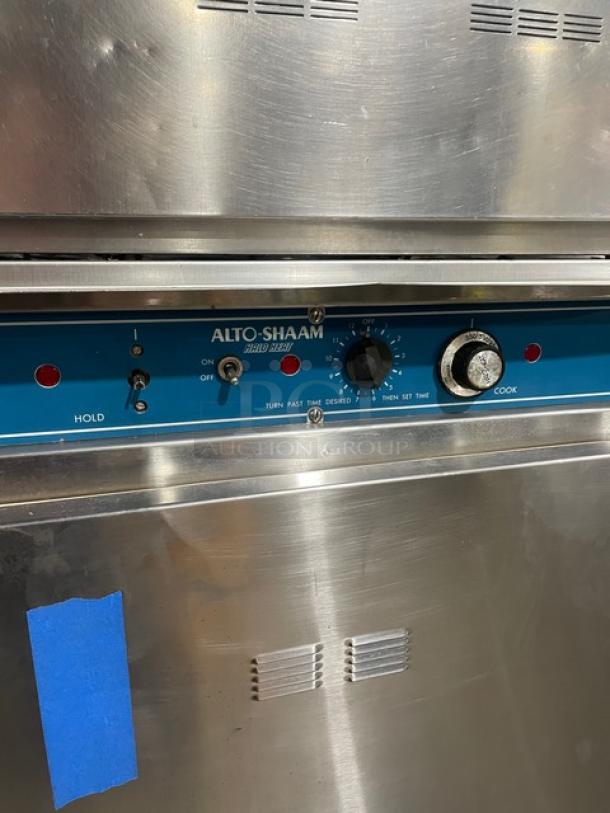 Alto-Shaam Halo Heat stainless steel double-stacked cook/hold oven with wired rack, control panel shown, on casters.