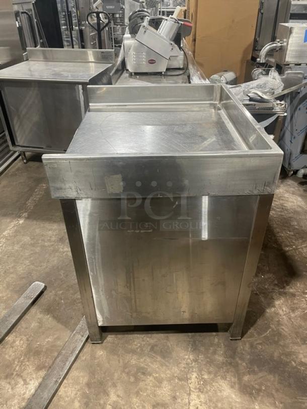 Commercial stainless steel worktop table with enclosed cabinet base, up-turned back and side splash, on legs. Good condition.