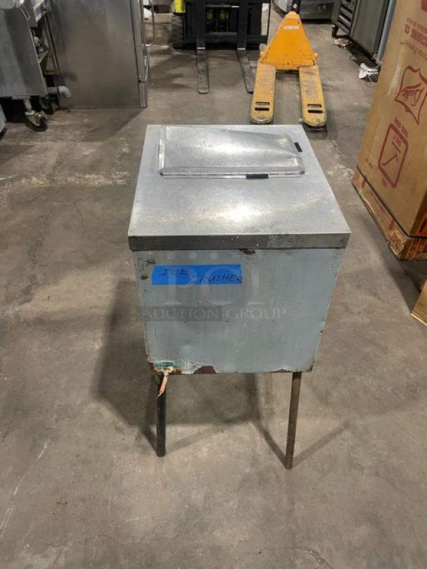 Commercial stainless steel ice crushing machine with wooden style finish, on legs. Label indicates "Ice Crusher." Used condition.