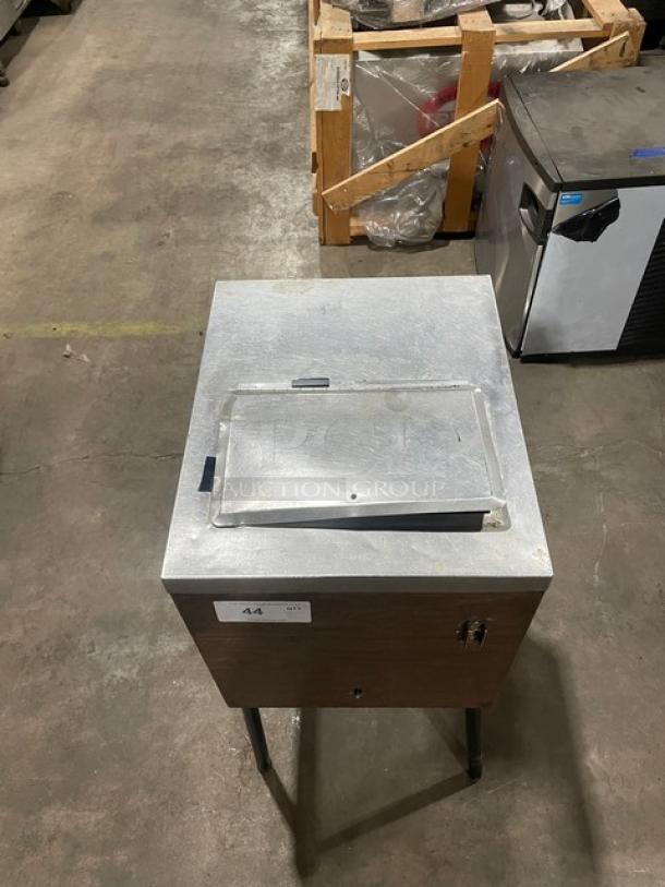 Commercial stainless steel ice crushing machine with wooden style finish and legs. Visible label indicates item number 44.