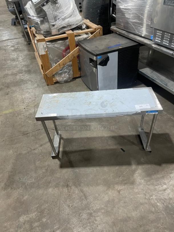 BK Resources stainless steel overhead shelf, 36"x12", model BKOSS1236. Visible wear on surface, sturdy structure.
