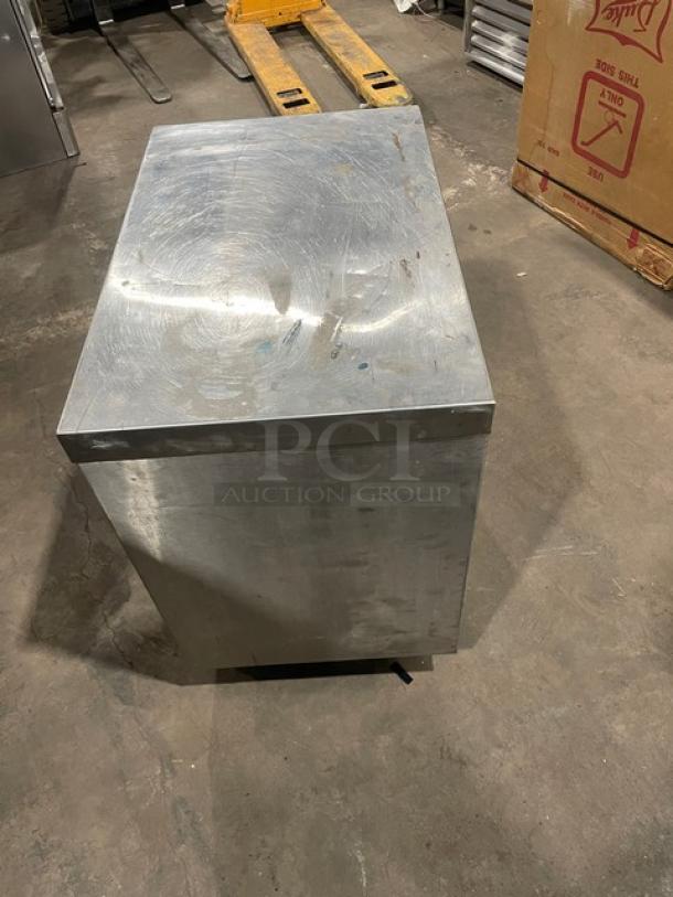 Commercial stainless steel enclosed cabinet worktop on casters. Features durable construction, portable design, and enclosed storage.