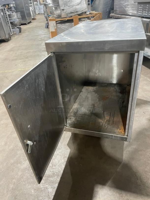 Commercial stainless steel dry enclosed cabinet on casters, open door, visible interior, some wear, secure lock handle.