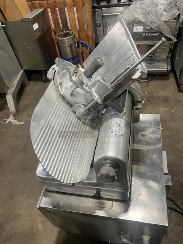 Commercial electric-powered deli meat slicer, Model 1712. Features: 115V, 1 Phase, on legs. Serial Number: 1624705.