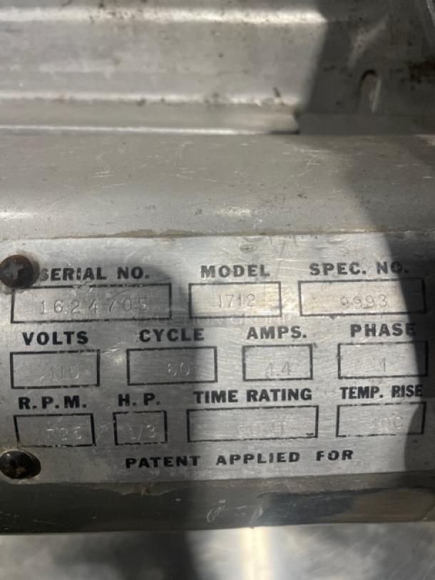 Commercial electric deli slicer, model 1712, SN: 1624705. Operates on 115V, 1 phase. Countertop design on legs.