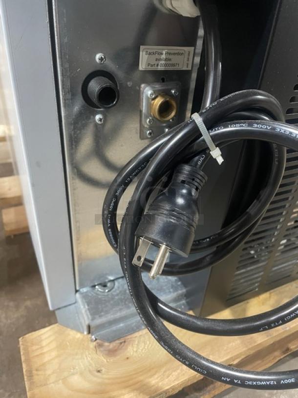 "Manitowoc RF0644A commercial ice machine power cord and back panel, new condition with backflow prevention label and power plug."