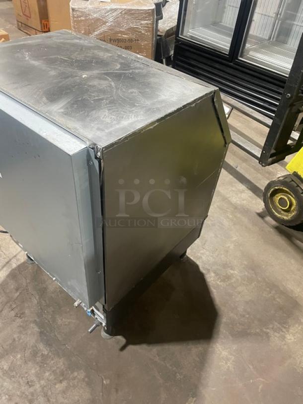 Manitowoc stainless steel undercounter ice machine/bin combo, electric-powered, SN: 310620659, on legs, 115V, 1 phase, good condition.