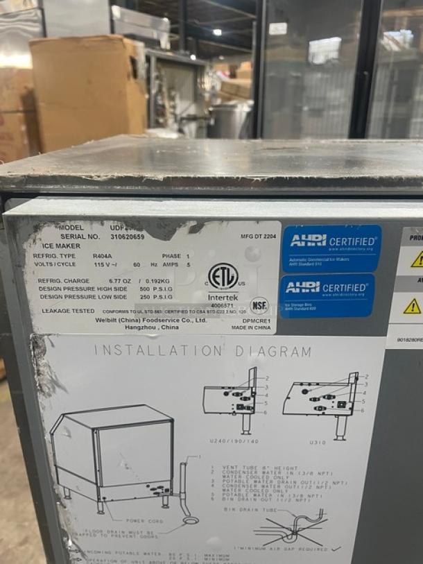 Manitowoc stainless steel undercounter ice machine, SN: 310620659, 115V, 1 phase, on legs, features installation diagram and certifications.