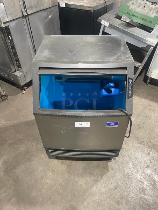 Manitowoc stainless steel undercounter ice machine, electric-powered, SN: 310620659, 115V, 1 phase, on legs, open bin.