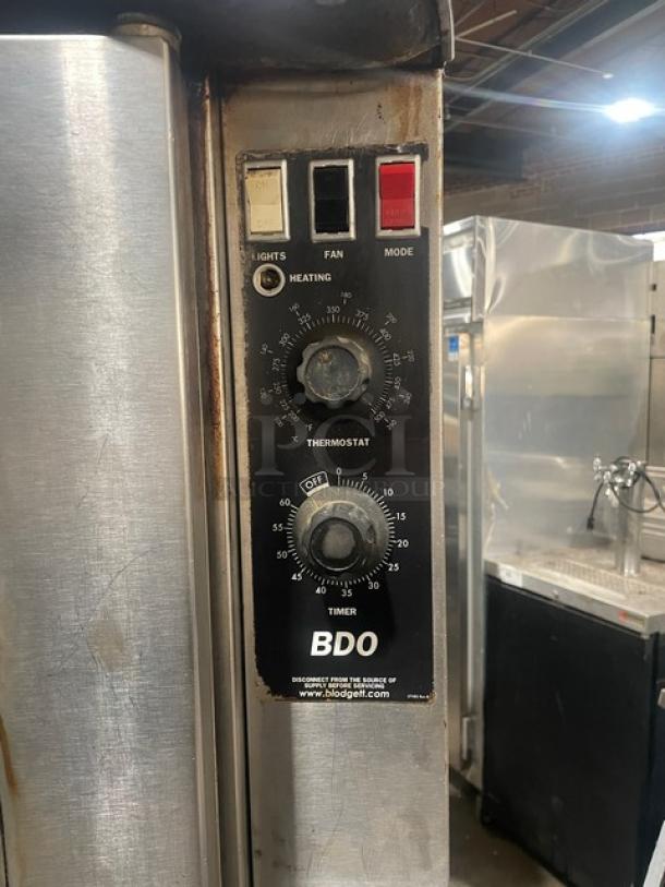 Blodgett BD0 Series commercial gas oven, double stacked, stainless steel, on casters. Features thermostat and timer controls.