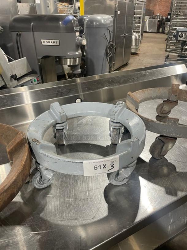 Commercial heavy-duty round trash can dolly on casters. Used condition. Label reads "61 X 3." Ideal for waste management.