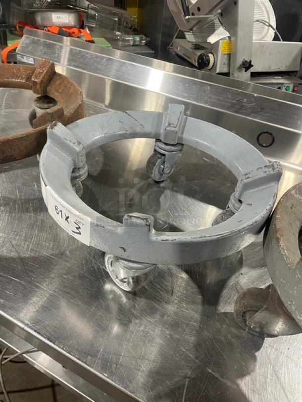 Heavy-duty round trash can dolly with casters, metal, used condition, visible label "61X" with a number, ideal for commercial use.