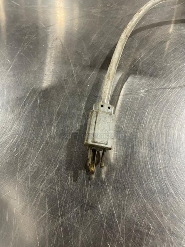 Edlund Model 266 stainless steel electric can opener, single-speed, with legs. Serial number 139203. Cord visible, worn condition.