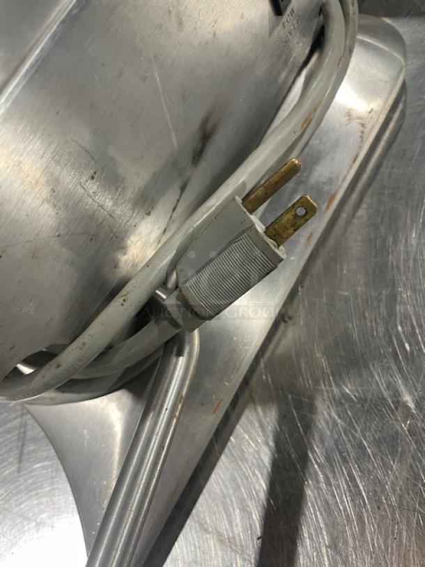 Edlund Model 270 stainless steel electric can opener, 2-speed, heavy-duty, 115V, shown with power cord on metal surface.