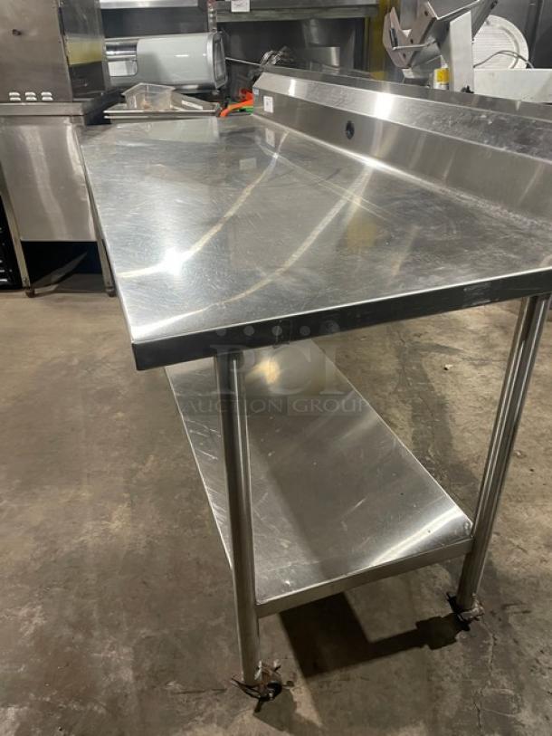 Commercial stainless steel worktop prep table with single undershelf, up-turned backsplash, and casters. Excellent condition.