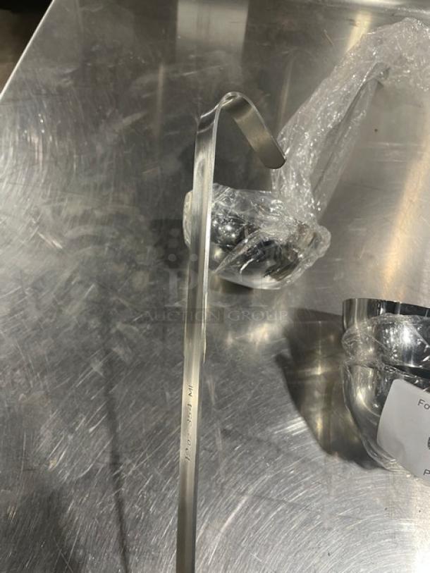 New Adcraft stainless steel 12 oz. serving ladle, model LD-12, in pristine condition. Visible product markings indicate authenticity.