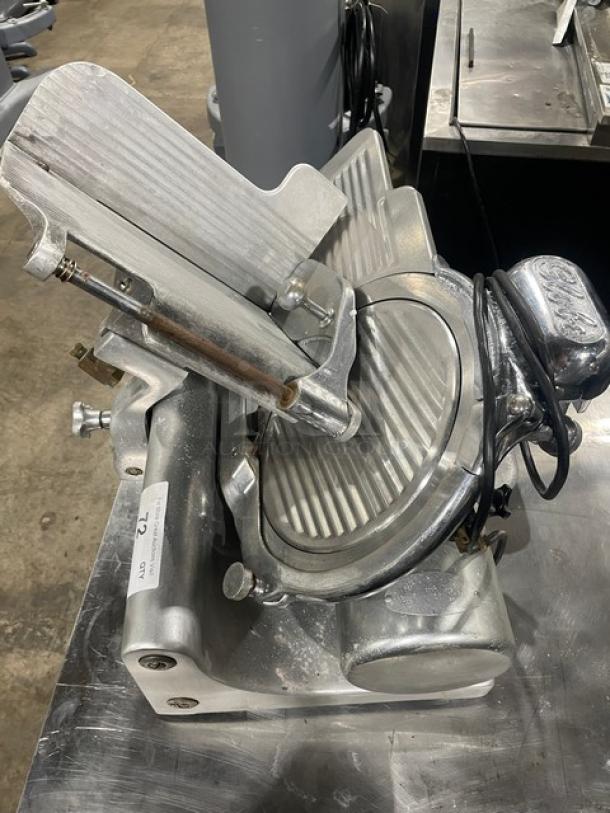 Globe Model 660 electric deli meat slicer on legs, SN: 674425, metallic finish, visible power cord, in good condition.