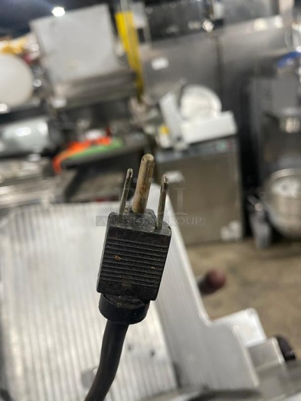 Globe Model 660 electric deli meat slicer, SN: 674425, in used condition with visible power plug.