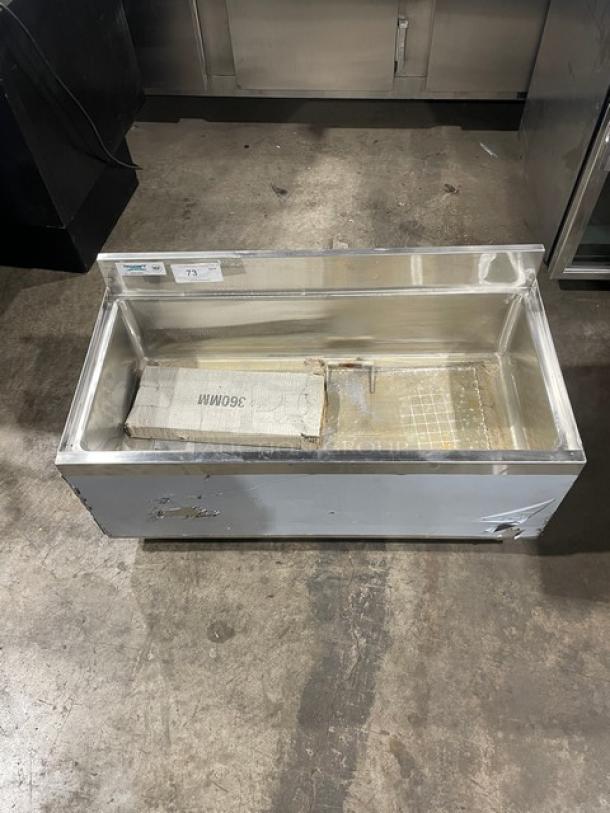 Regency stainless steel single well ice bin, new scratch-n-dent, with upturned backsplash and legs. Visible exterior wear.