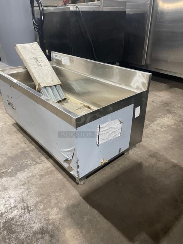 Regency commercial stainless steel single well ice bin with up-turned backsplash and legs, scratch-n-dent, minor visible wear.