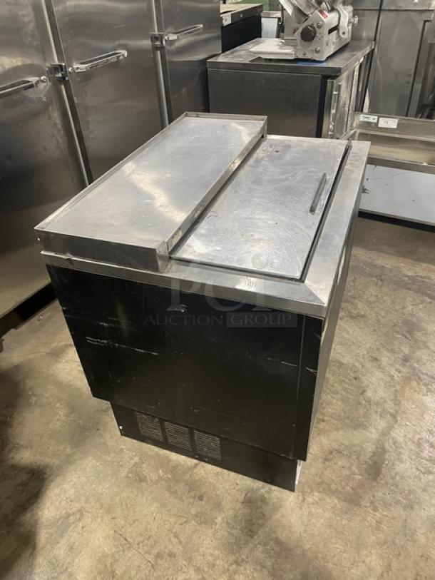Beverage-Air black powder-coated/stainless steel bottle cooler with easy-slide lid and poly-coated wired rack. Great condition.