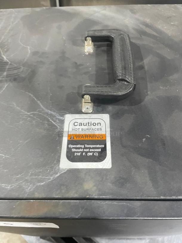 Forbes Ultra Series Black 3-Tier Insulated Food Carrier, Model 6272, with stainless steel interior. Caution label warns of hot surfaces.