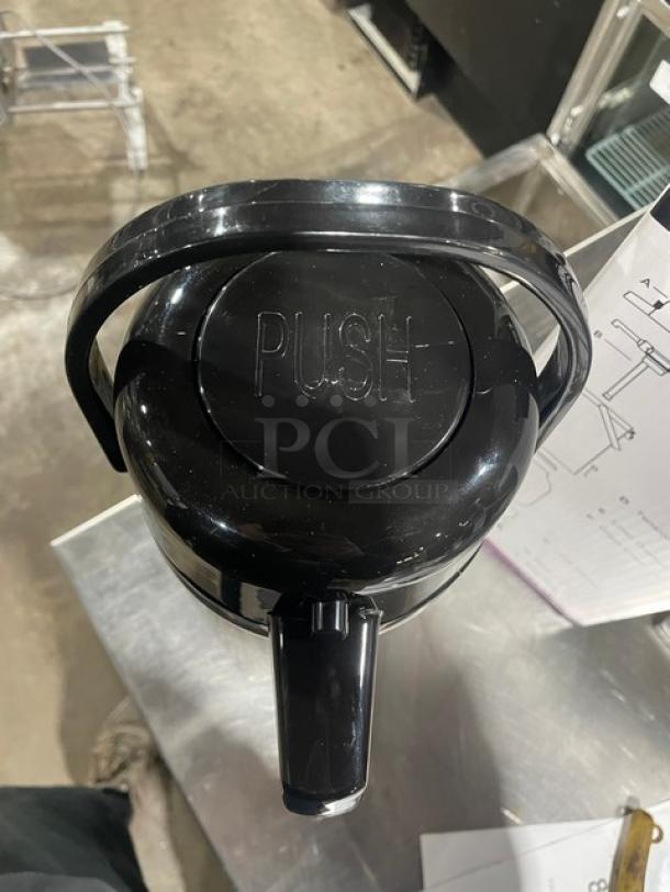 Eco-Air stainless steel glass lined airpot with black lid, featuring a "PUSH" button on top, in new condition.