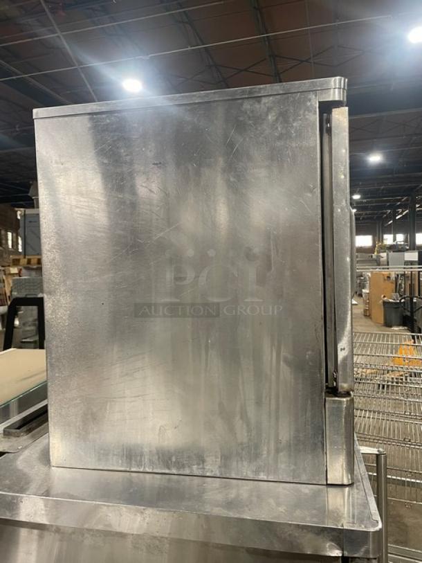 Blodgett stainless steel convection oven, natural gas-powered, single door, half size, includes wired oven rack, shows wear.