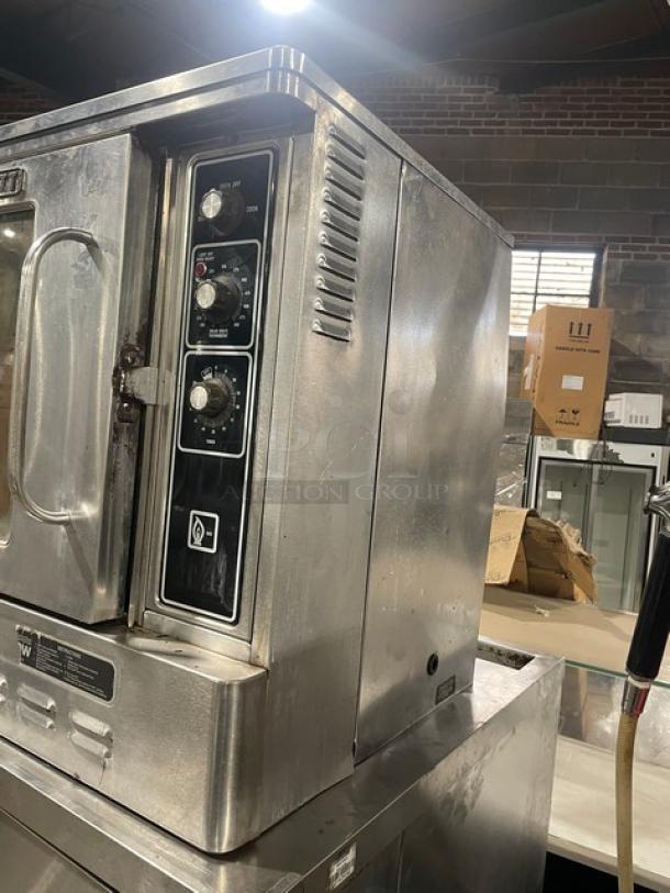 Blodgett stainless steel natural gas convection oven, single door, half size, with wired oven rack, control panel visible.
