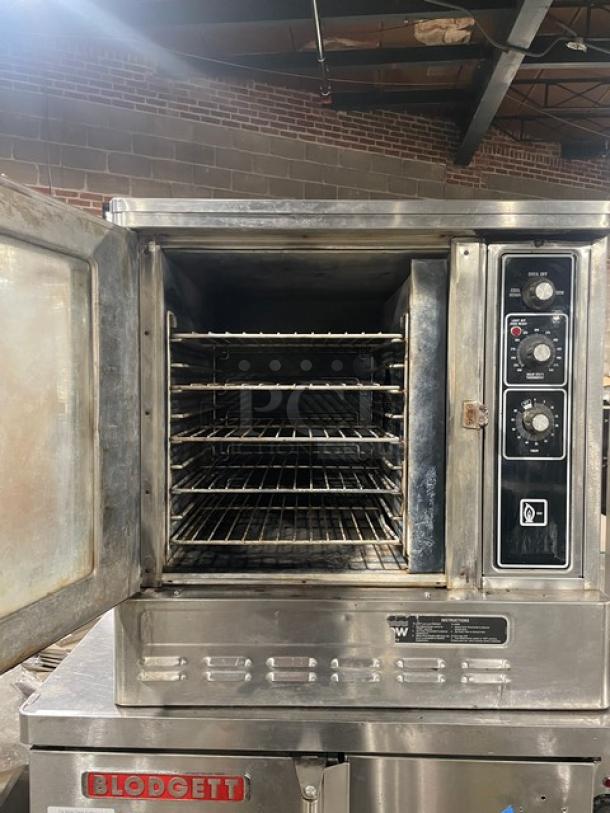 Blodgett commercial stainless steel natural gas convection oven. Single door, half size, wired oven rack, visible controls.