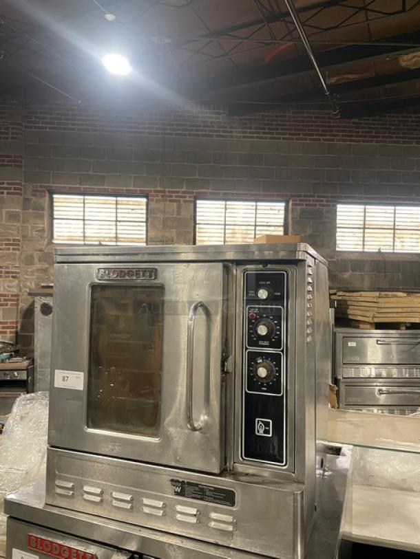 Blodgett stainless steel single-door half-size convection oven, natural gas powered, with wired rack and control panel.