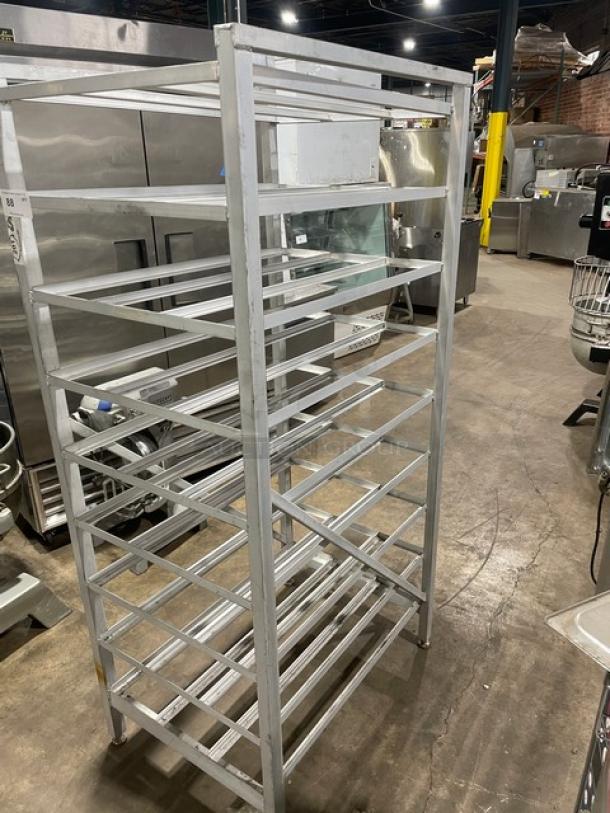 Commercial stainless steel storage can rack on legs, featuring multiple shelves. Ideal for restaurant use. Good condition.