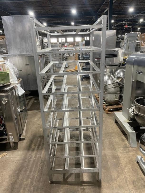 Commercial stainless steel storage can rack on legs, used condition. Multiple shelves, ideal for industrial kitchens.