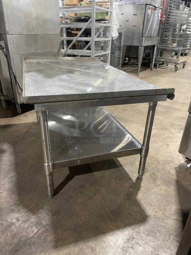 Commercial stainless steel food prep table with under-shelf and sturdy legs. Used condition, suitable for kitchen or restaurant use.