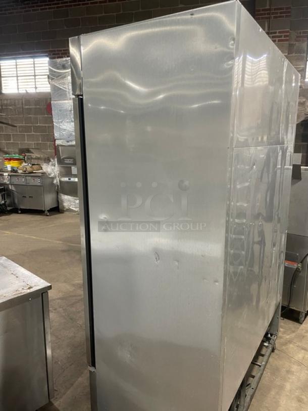 True T49F stainless steel 2-door reach-in freezer, electric powered, on casters. Features poly-coated wire racks.