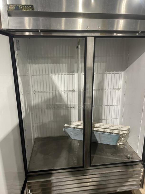 True T-49F commercial stainless steel 2-door reach-in freezer, with poly-coated wire racks, electric, on casters, 115V.