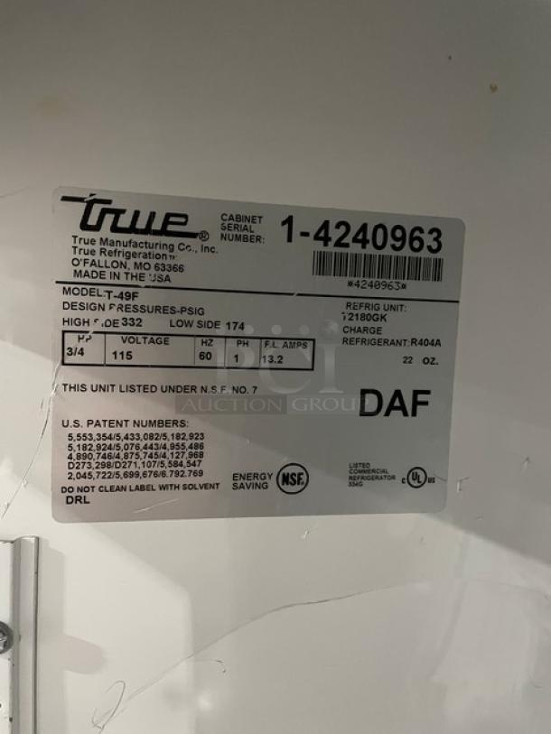 True T49F 2-Door Reach-In Freezer, stainless steel, poly coated racks, item SN 1-4240963, 115V, on casters, NSF certified.