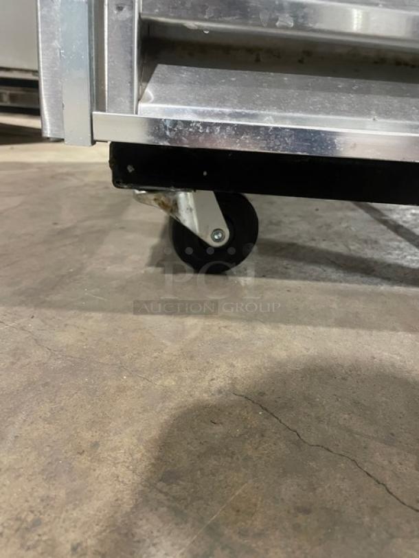 True T-49F commercial stainless steel reach-in freezer on casters, featuring poly-coated wired oven racks. Model: T-49F SN: 1-4240963.