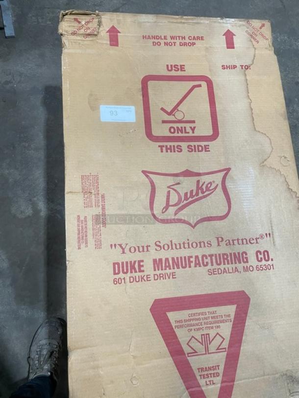 New Duke Aerohot Series stainless steel electric steam table in box, features 3 wells, cutting board, on legs.