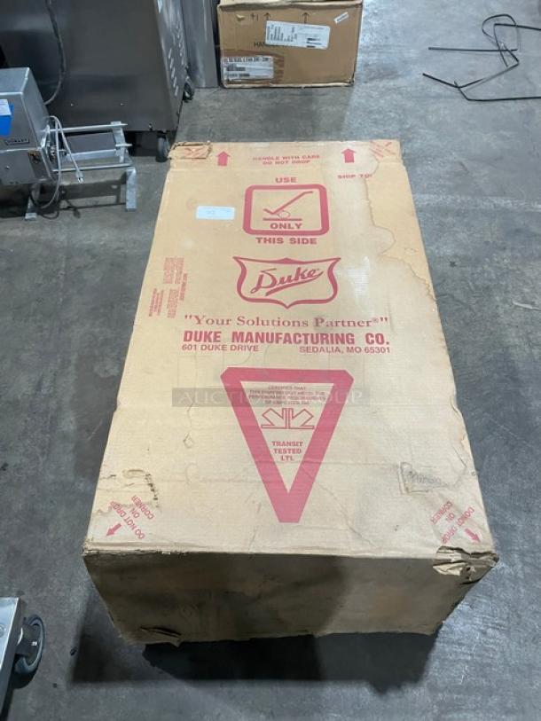 New Duke Aerohot Series stainless steel steam table in original packaging. Features 3 wells, cutting board, and legs.