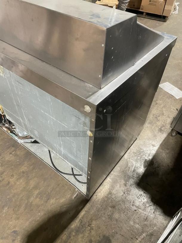 Delfield stainless steel refrigerated salad bar with sandwich prep table, featuring four refrigerated drawers underneath.