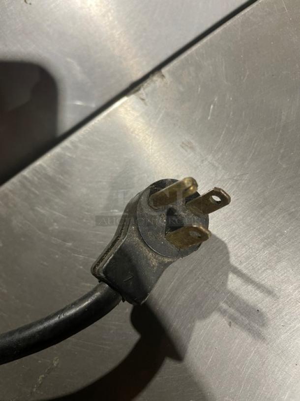 Delfield stainless steel refrigerated prep table plug. Durable, part of salad bar with four refrigerated drawers.