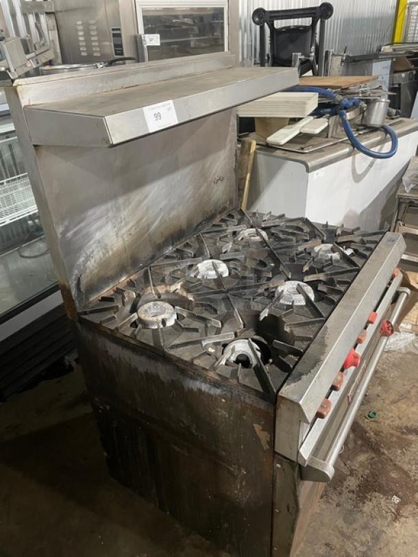 Vulcan commercial 6 burner natural gas range/oven combo with overhead salamander shelf, raised backsplash, stainless steel, on legs.