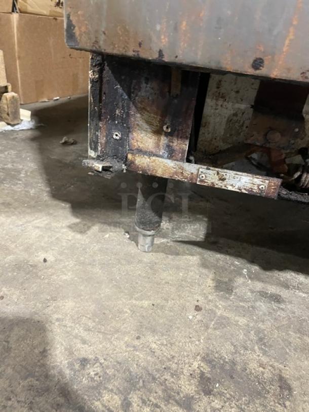 Vulcan 6-burner gas range/oven combo, stainless steel, overhead salamander shelf, raised backsplash, visible wear, on legs.